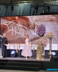 Pokaz „Troska” – spektakl w trzech aktach__Baletnica prezentuje pozycję, do której nawiązuje smukła kompozycja z fioletowych powojników_z lewej L-Stryjska_Targi Gardenia 2025_Florystyka